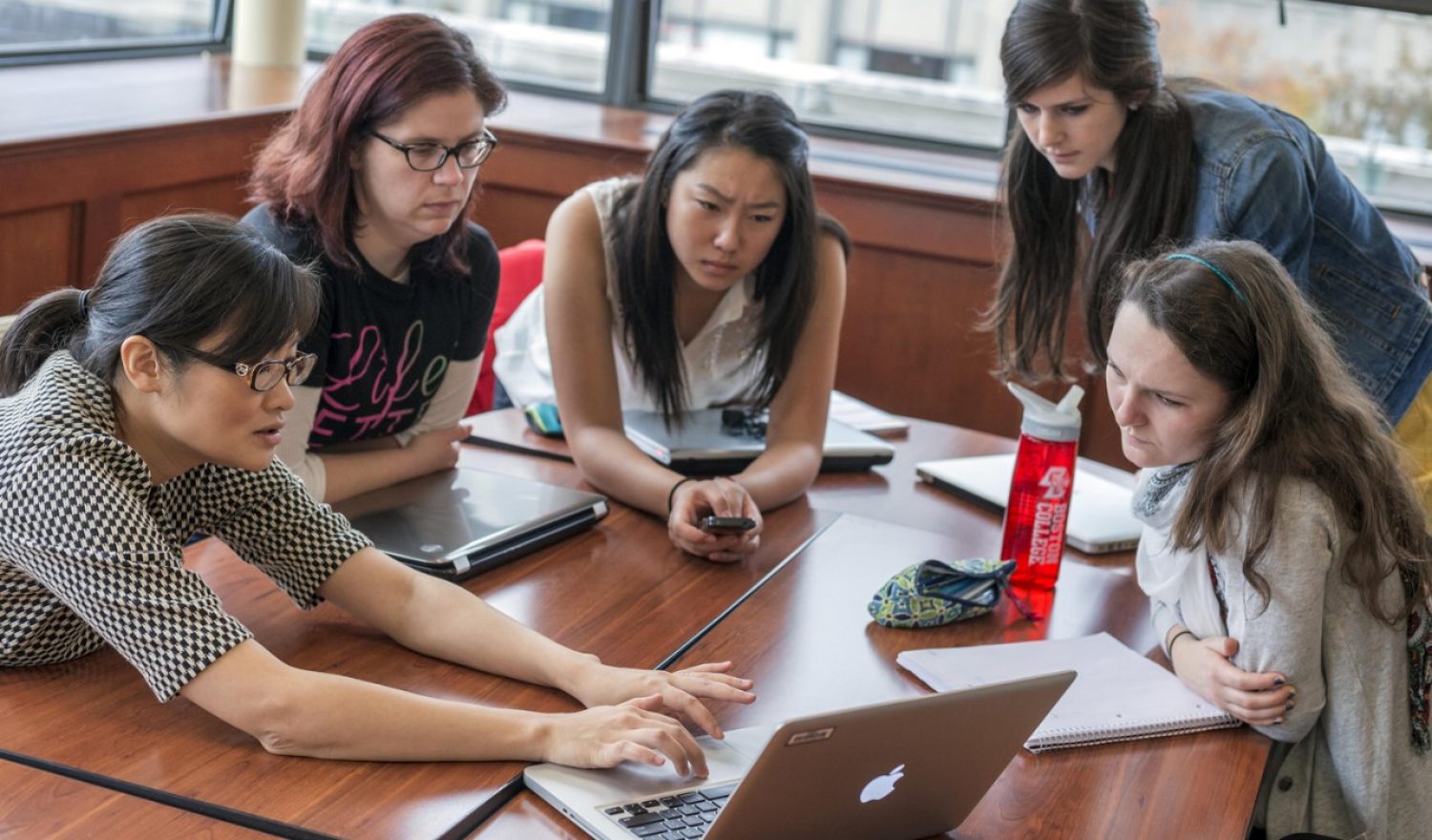 A group of ten students sitting in a circle having a conversation