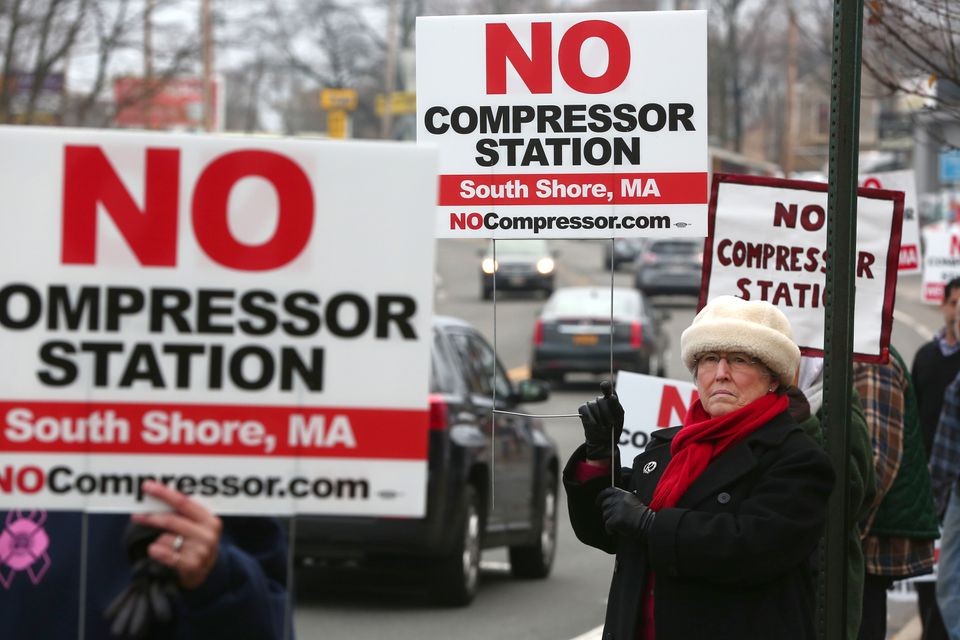 Image of a woman holding a protest sign