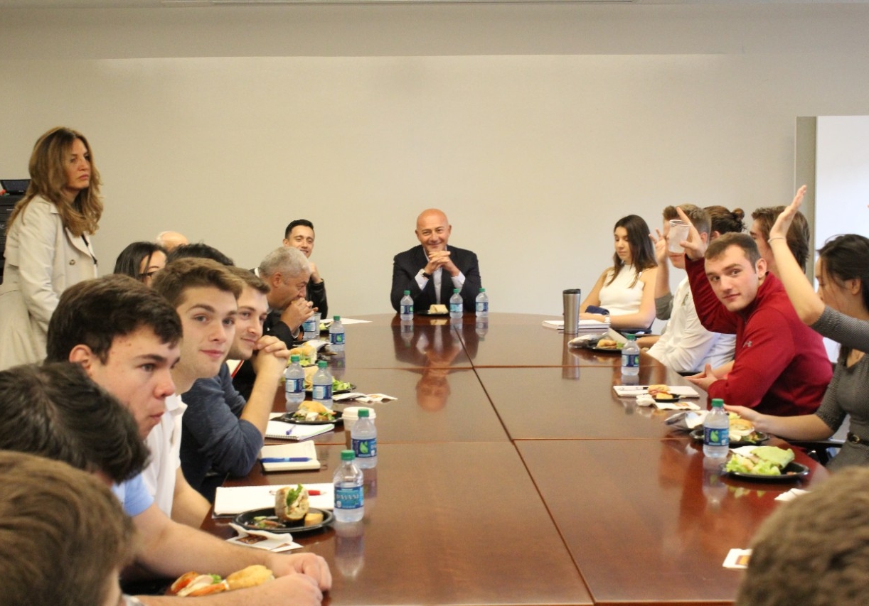 group photo of students at the lunch with hands raised