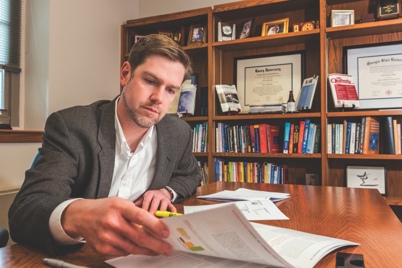 Jerry Kane looking at paperwork in his office