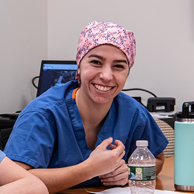 A student smiling with colleagues