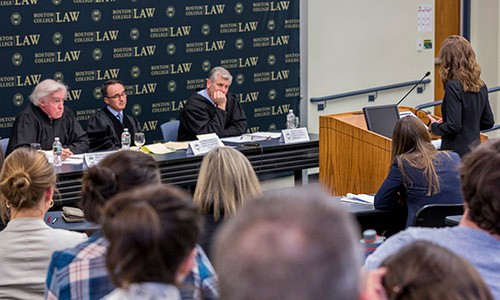 Student arguing before judges at Moot court competition