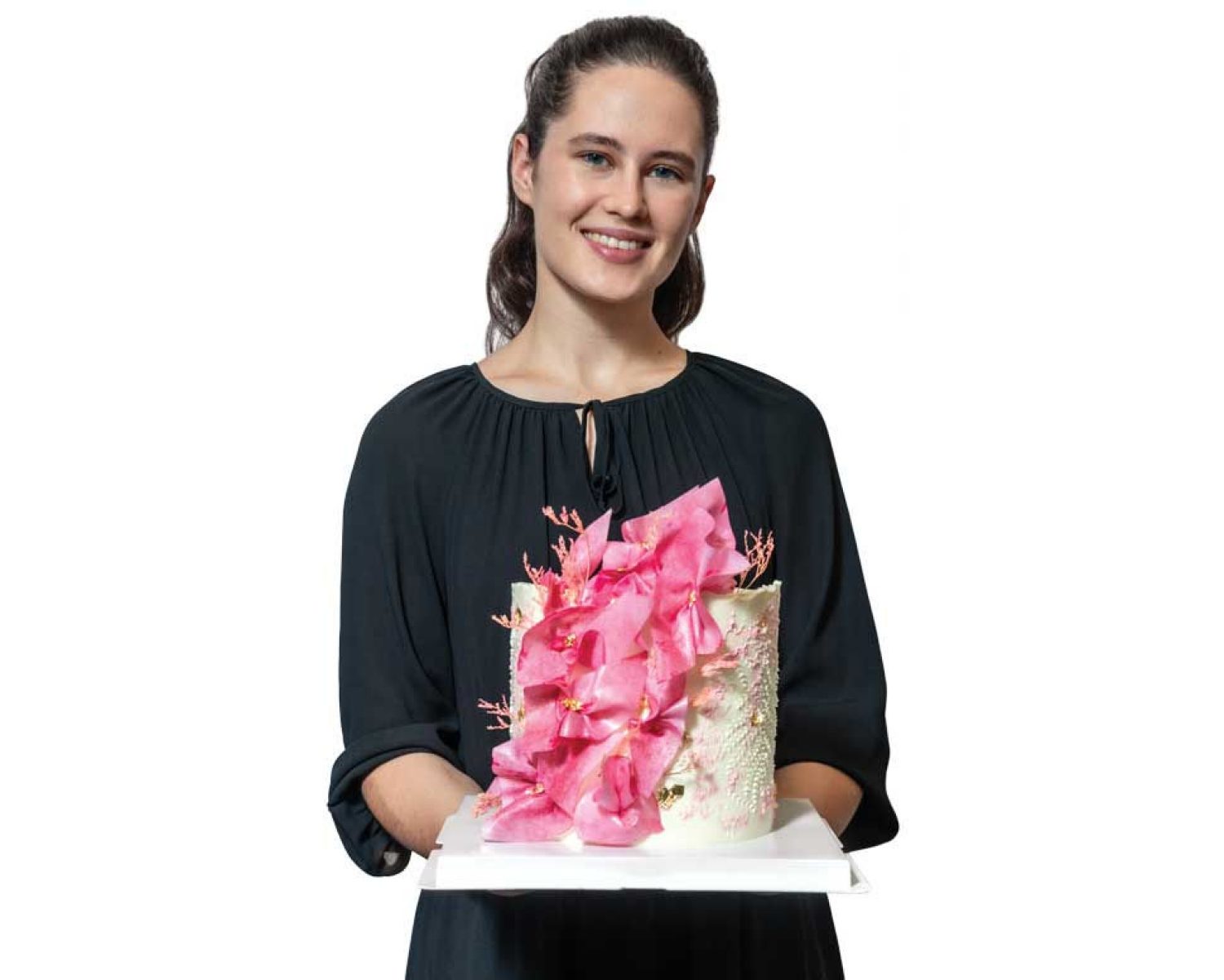 Photo of Ilona Znakharchuck ’21 holding one of her beautifully decorated cakes