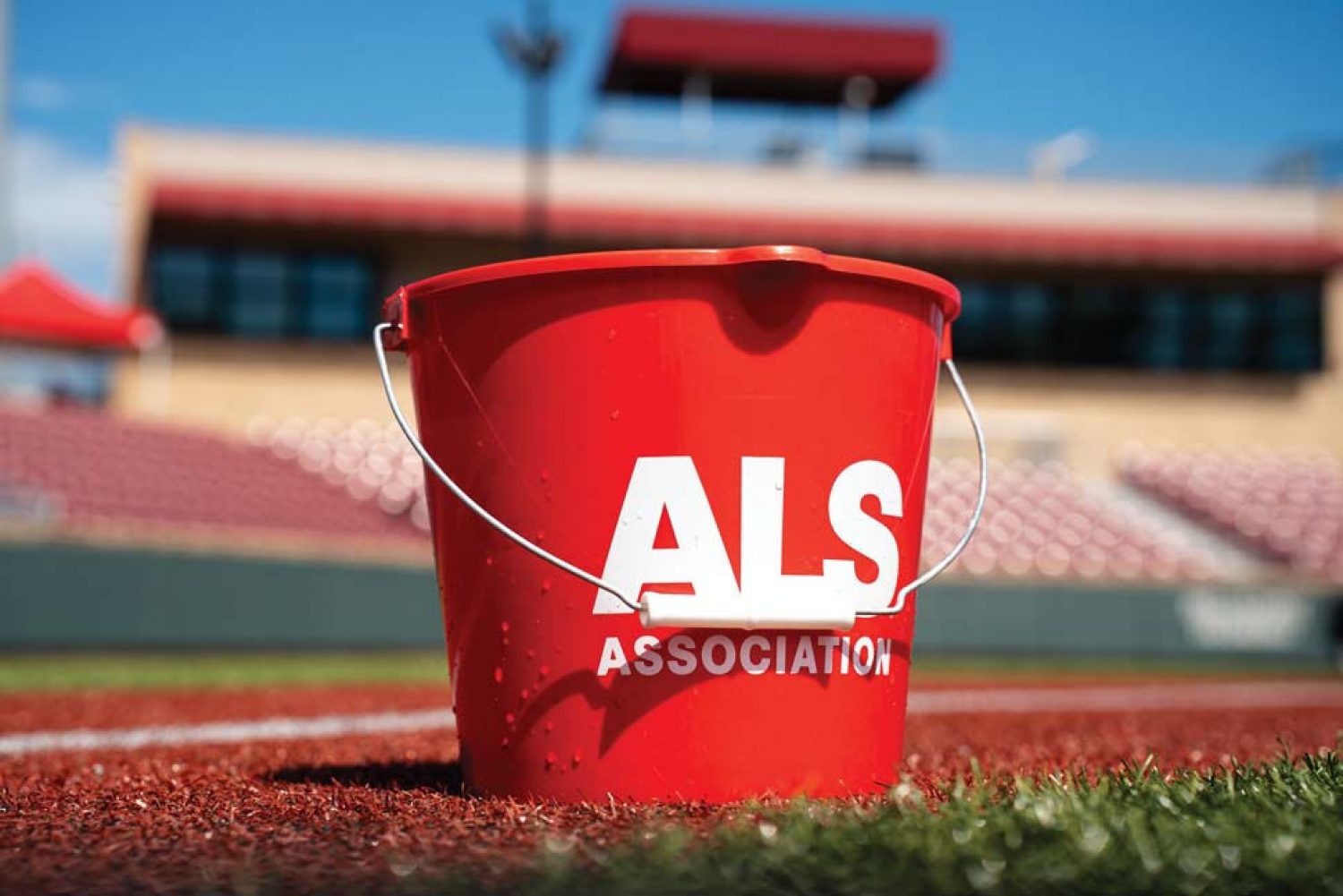 Photo of an ALS branded ice bucket on the turf of a baseball field