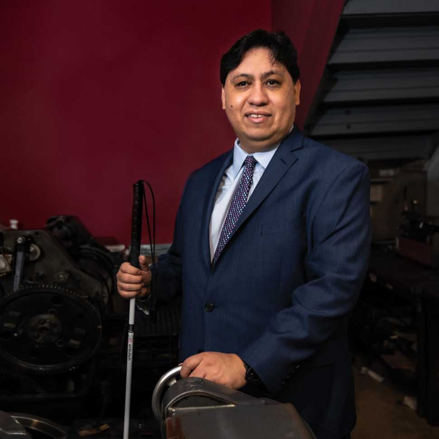 Joe Quintanilla photographed in the pressroom at National Braille Press