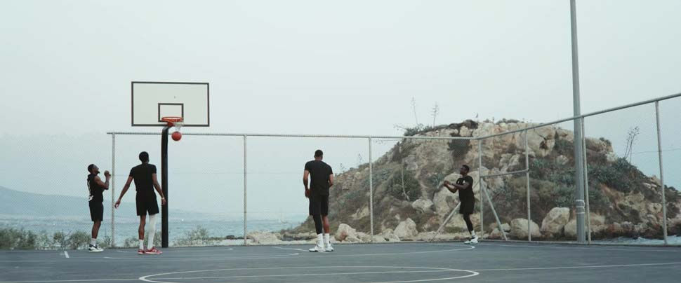 The four Antetokounmpo brothers on a basketball court in Greece.
