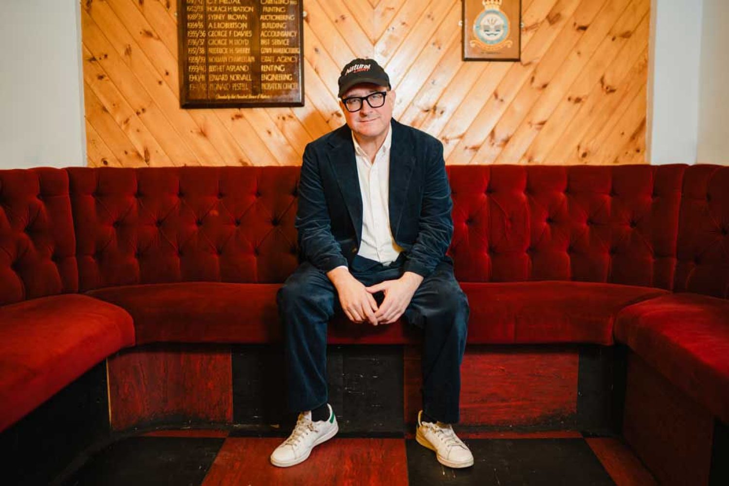 Craig Finn photographed seated on a couch.