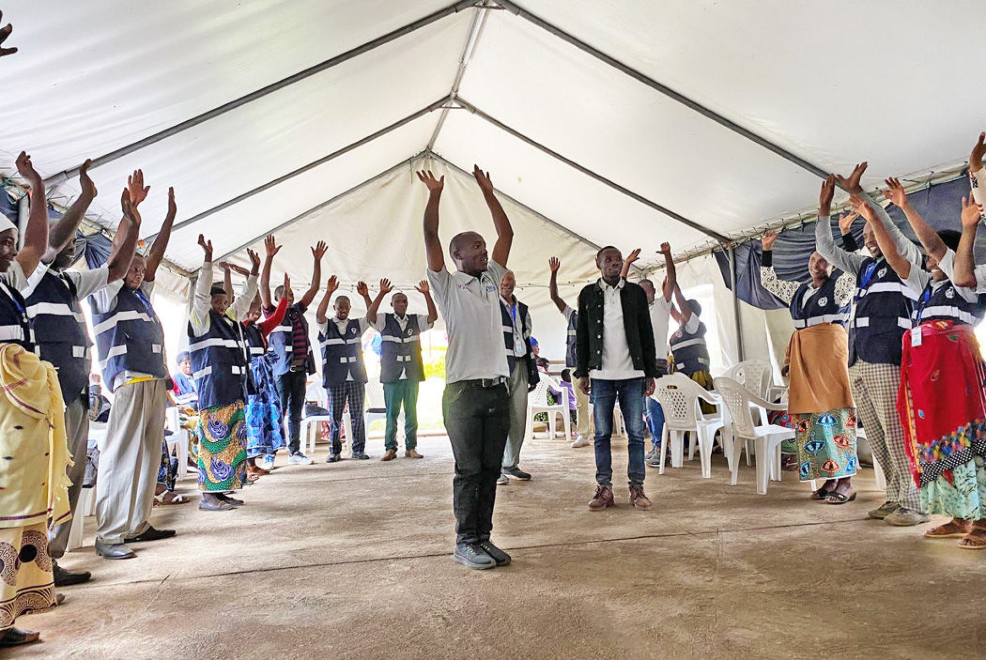 Men and women stretching in a tent