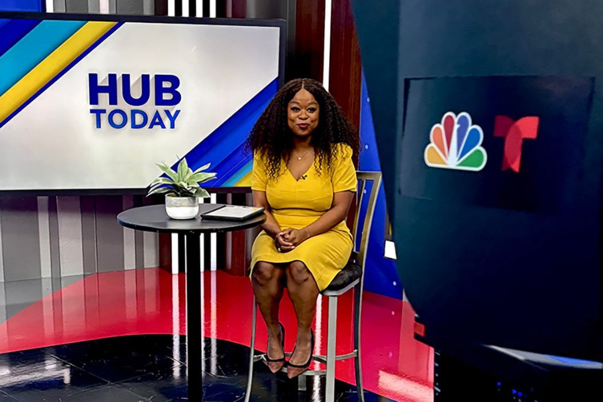 A tv host sitting on set