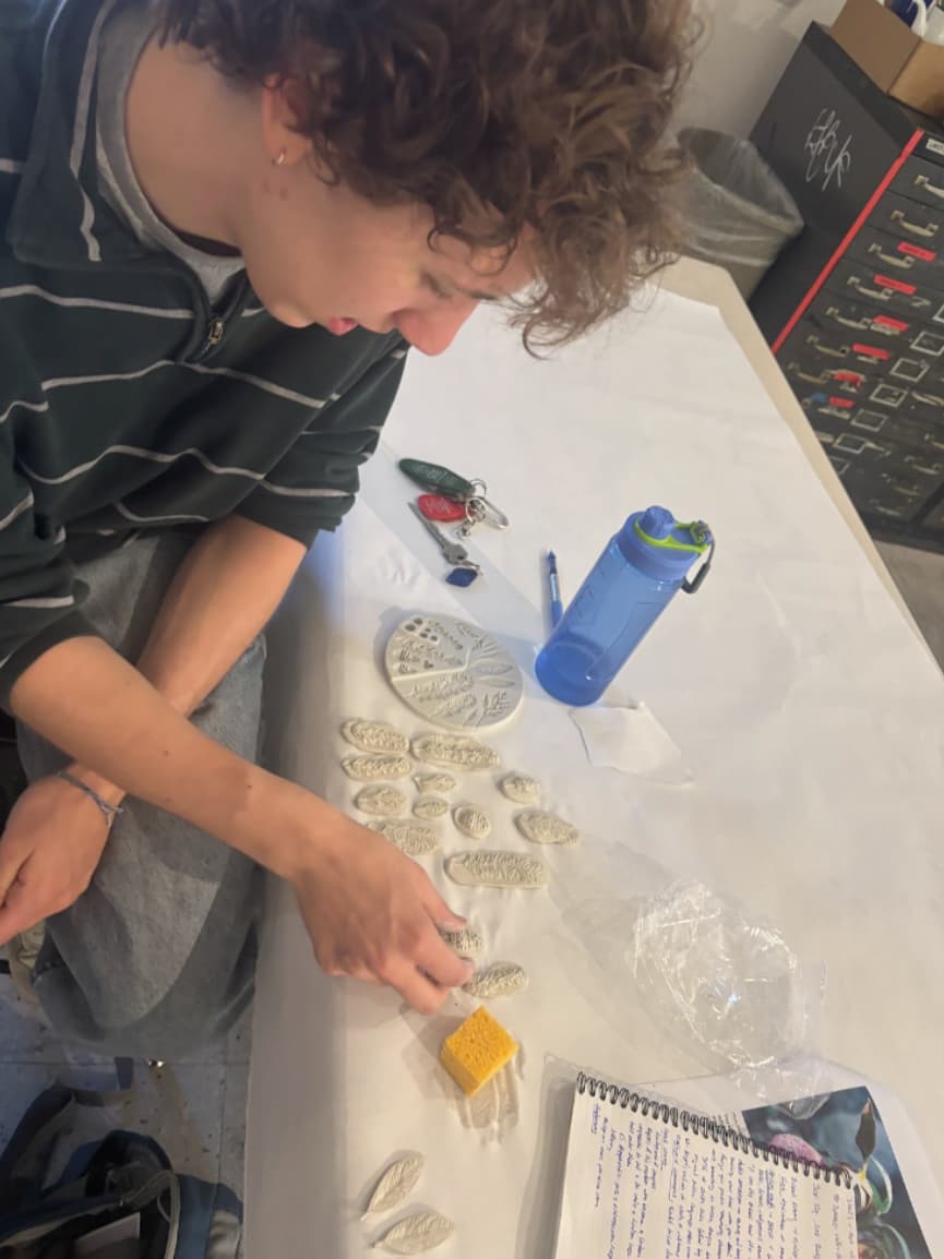 Student sculpting for the Votive Workshop