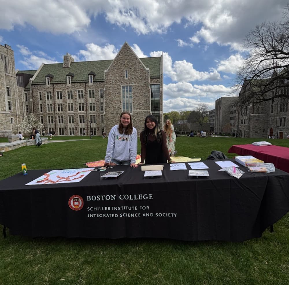 Schiller Institute sponsored Green Week table with 2 students running it