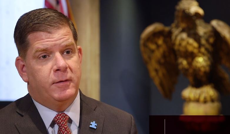 Marty Walsh beside an eagle statue