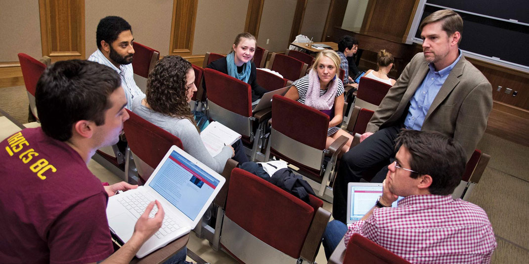 Prof. Jerry Kane speaking with students in his classroom