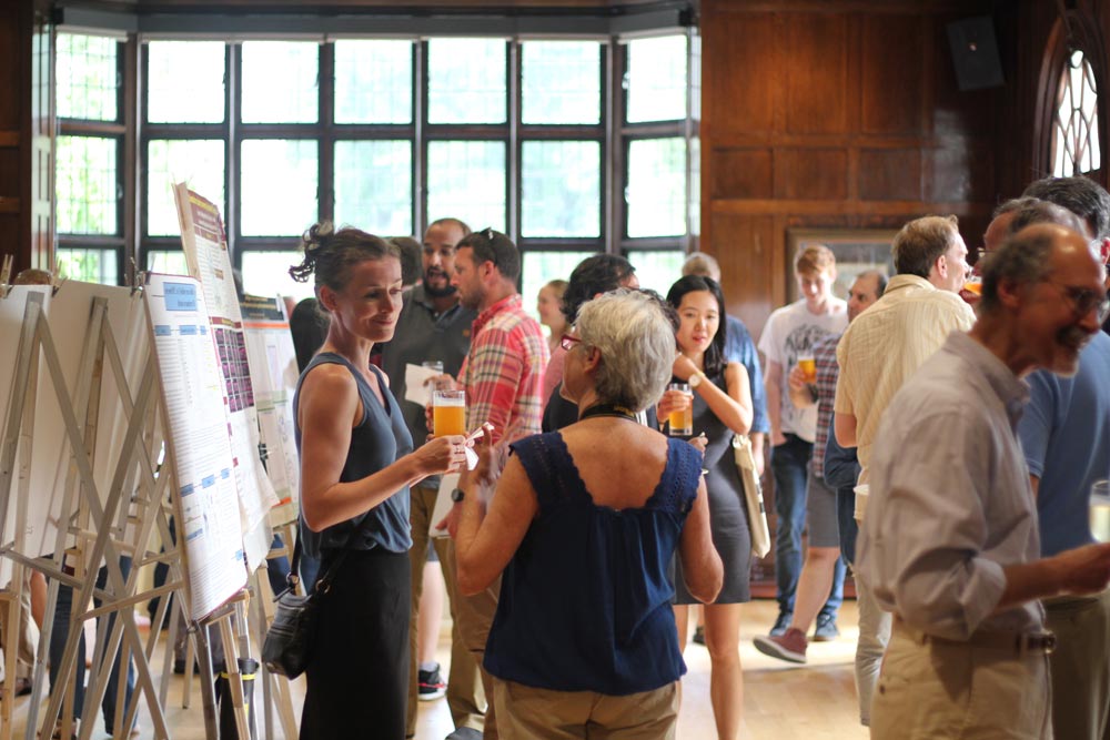 people talking around poster displays