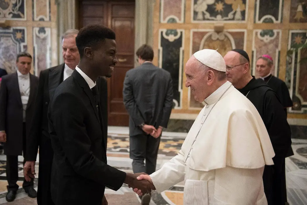 Pope Francis and Ramond shaking hands