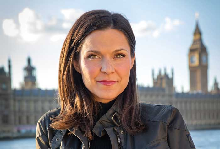 Maggie Rulli photographed in front of the Parliment buildings in London.