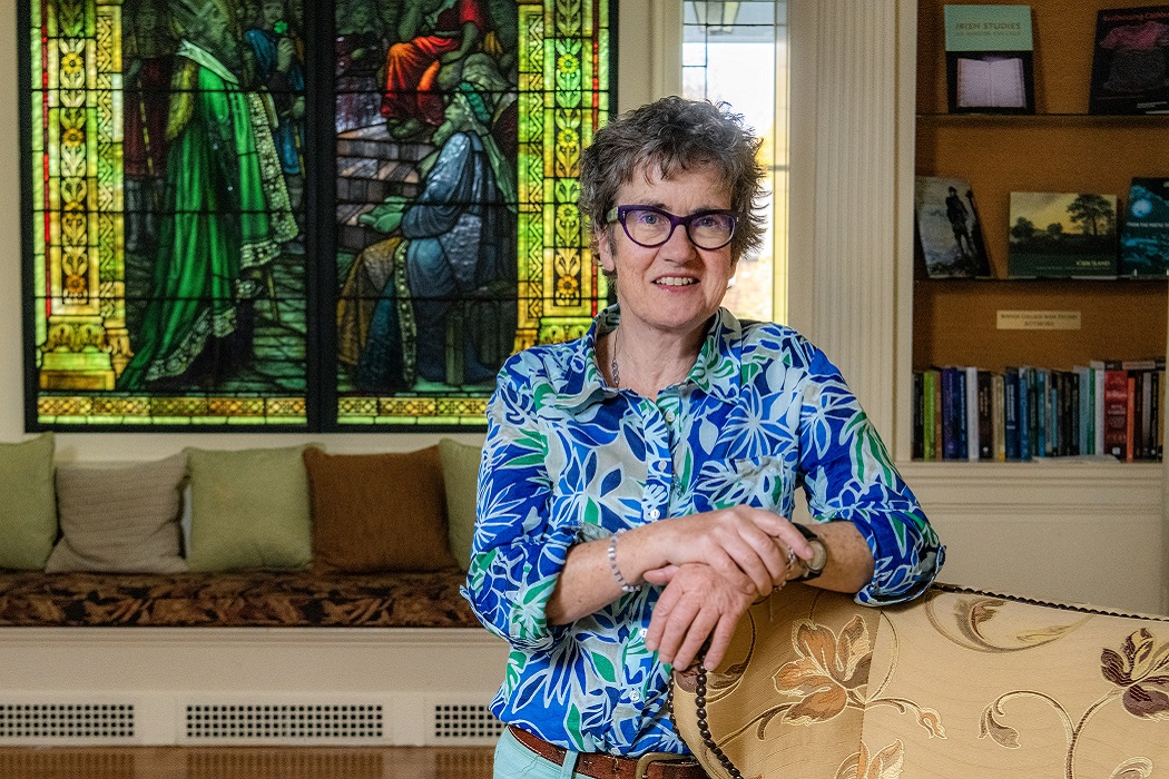 Patricia Palmer in front of a stained glass window