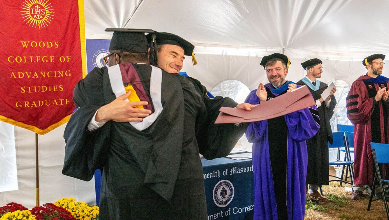 a graduation ceremony with people in cap and gown